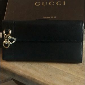 New GUCCI black soft leather wallet gold accents.